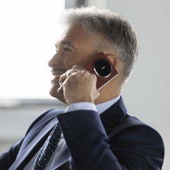 A person in a suit talking on a phoneAI-generated content may be incorrect.